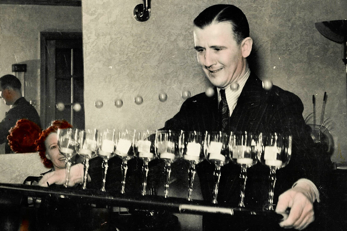 Charlie Carrer entertaining with a cocktail trick.